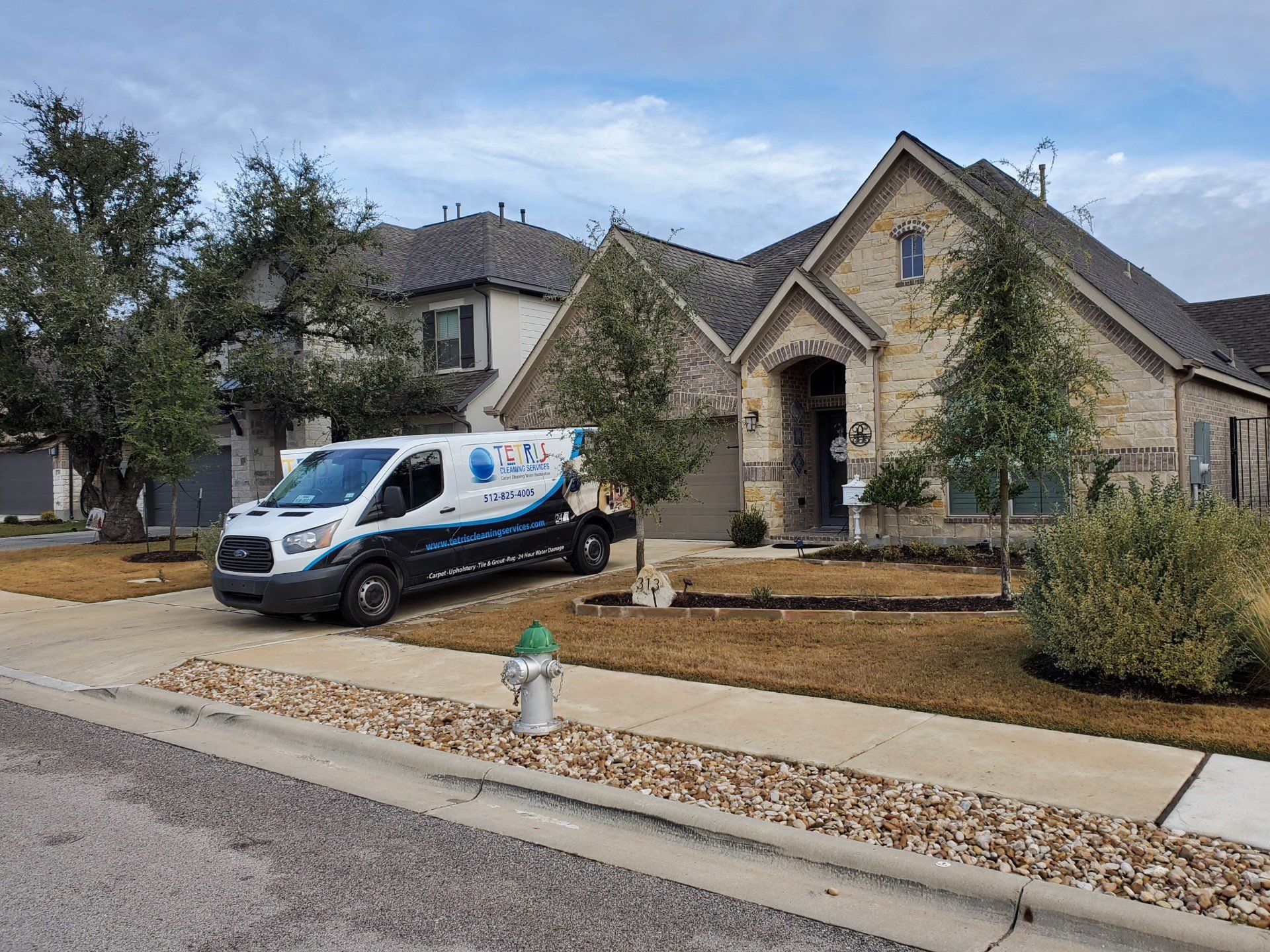 Tetris Cleaning Services van parked outside a stone house in Leander